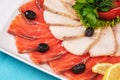 Mediterranean fish sliced Ã¢â¬â¹Ã¢â¬â¹salmon, tuna and trout with vegetables, greens, lemon and black olives Royalty Free Stock Photo